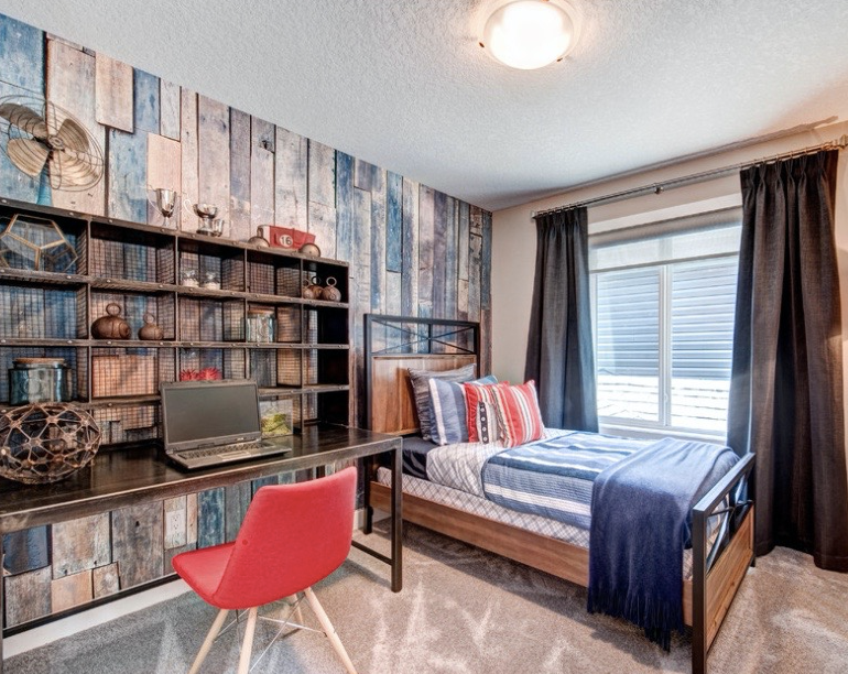 A bedroom with a bed , desk , chair and laptop.