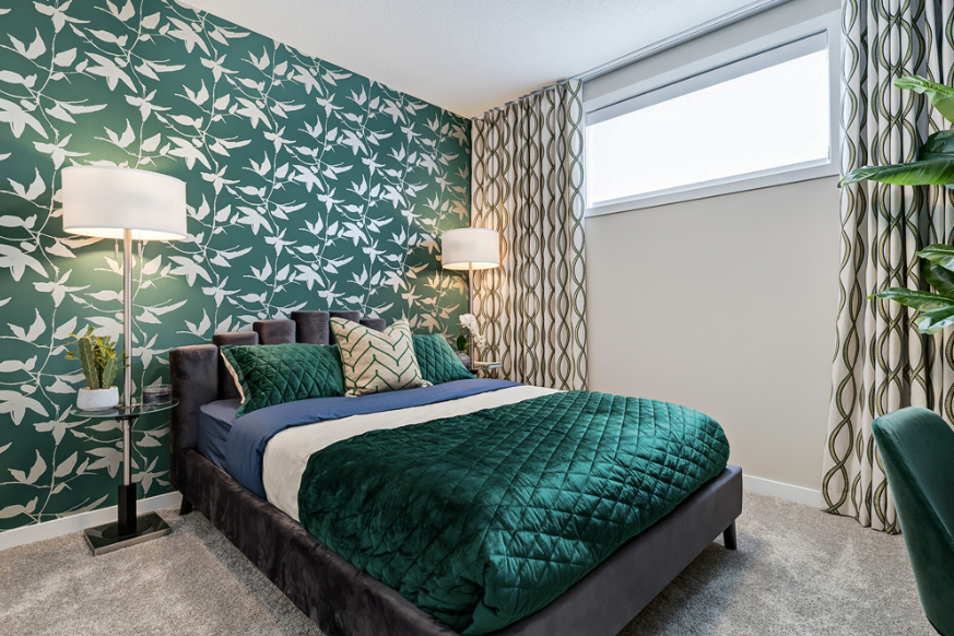 A bedroom with a bed , two lamps , and a window.