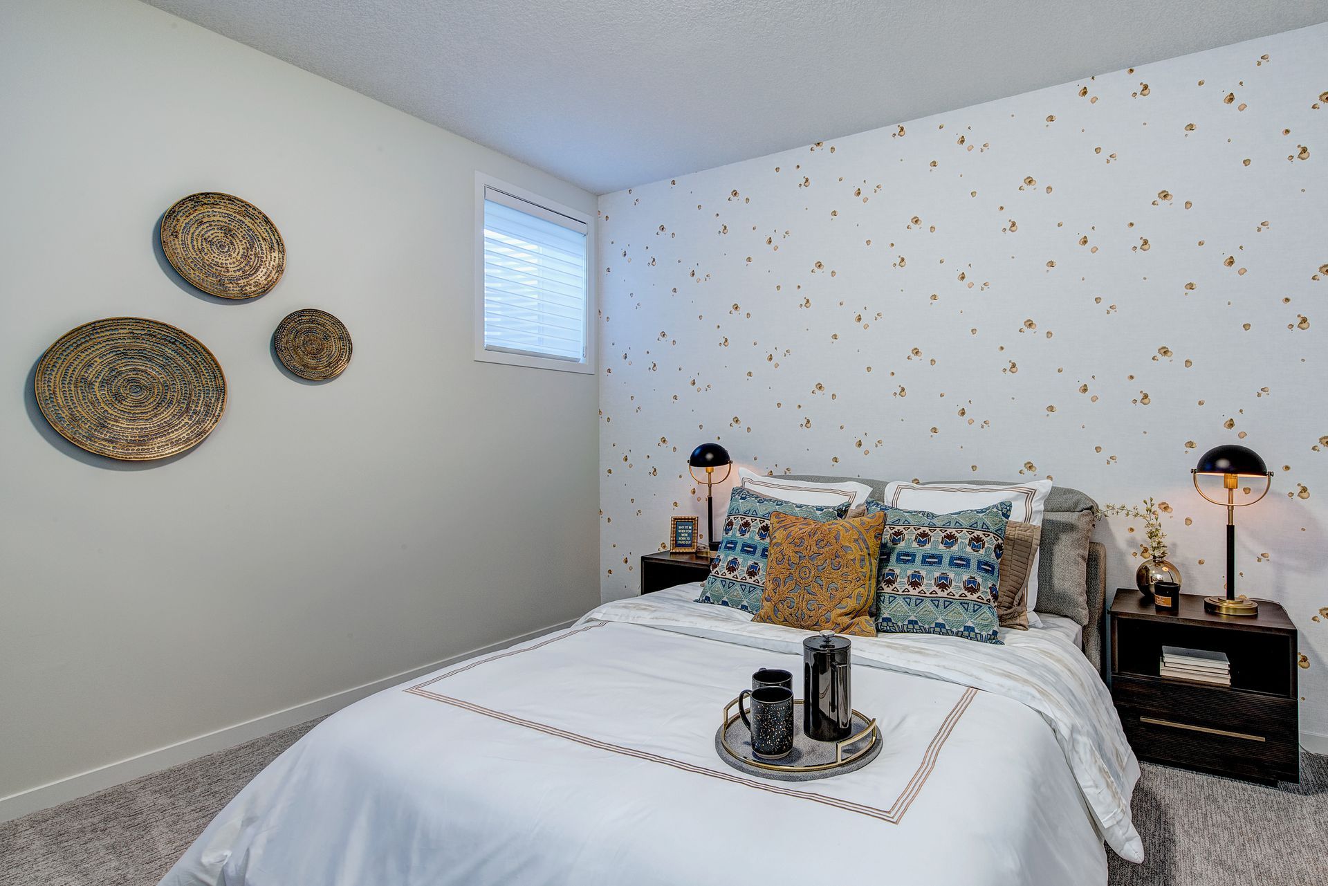 A bedroom with a bed , nightstands , and a window.