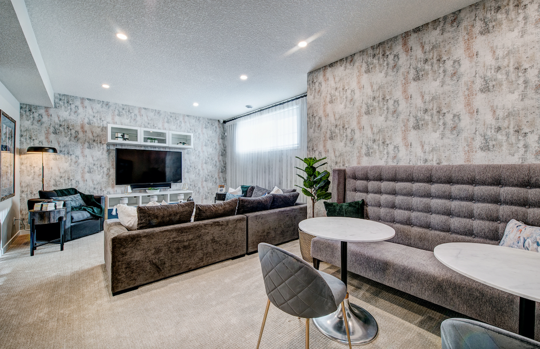 A living room with a couch , chairs , tables and a television.