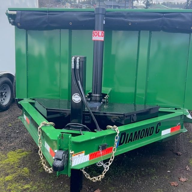 A green dumpster trailer with the word diamond on it
