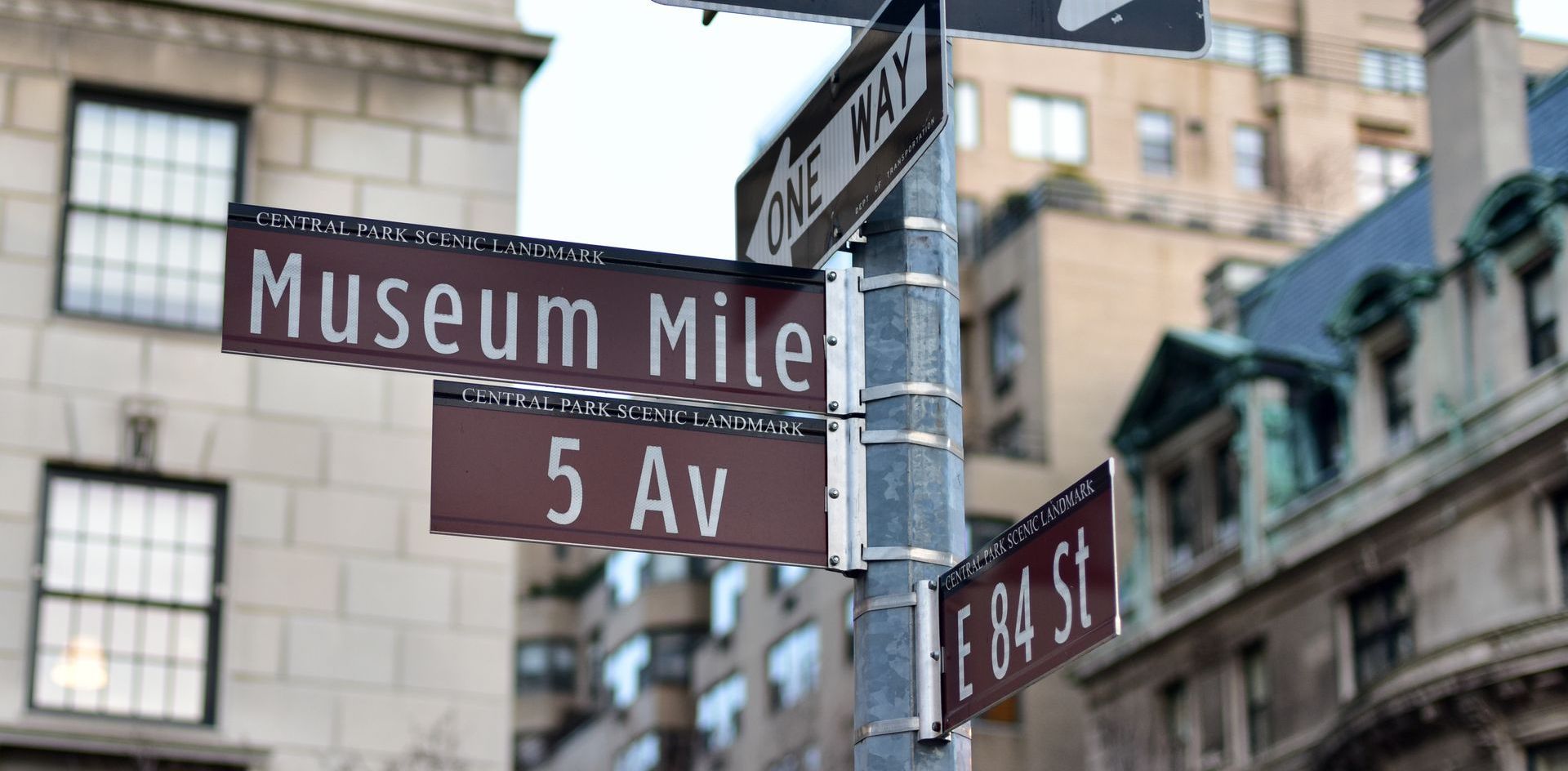 A street sign for museum mile and 5 av