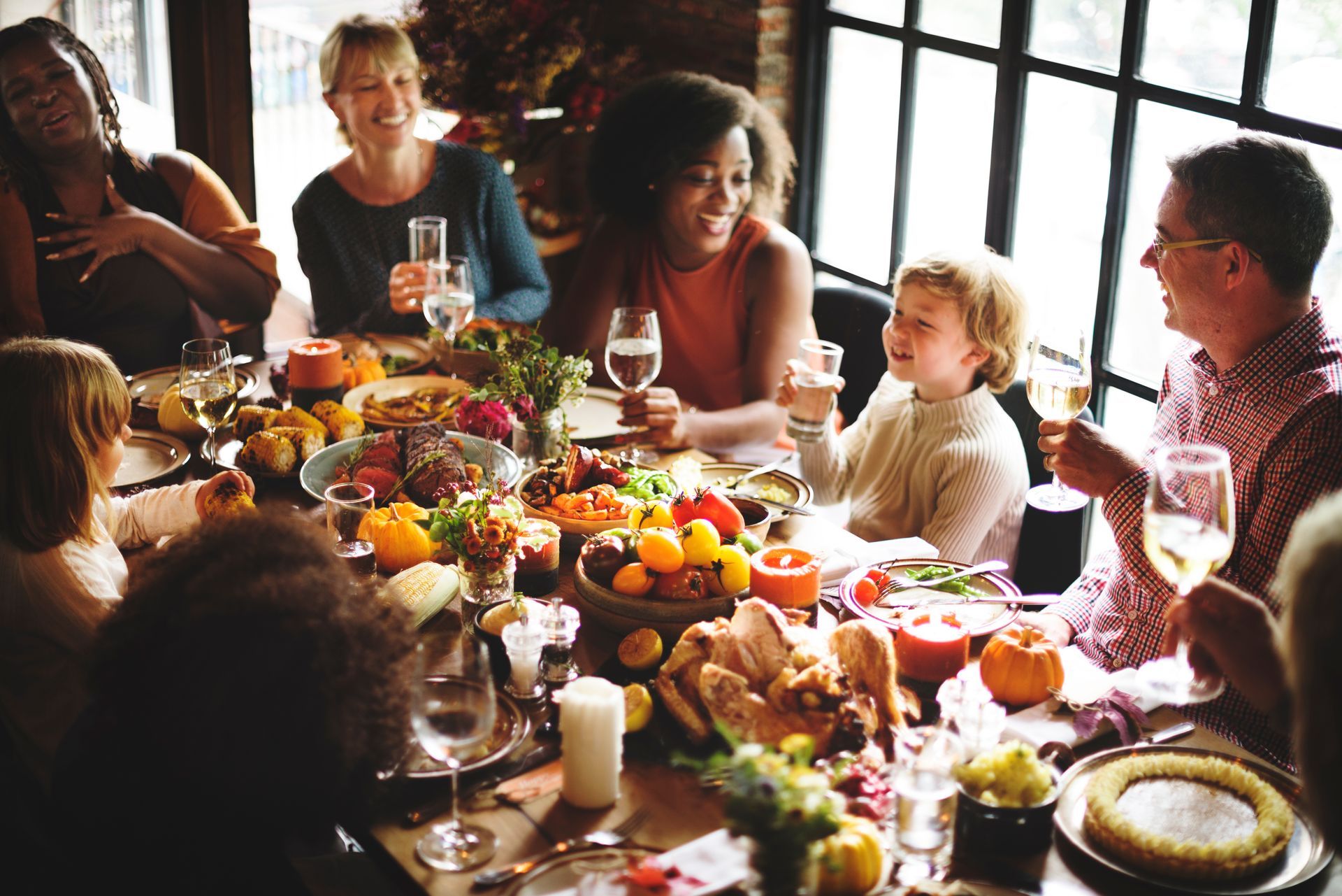 A group of people are sitting around a table eating food.