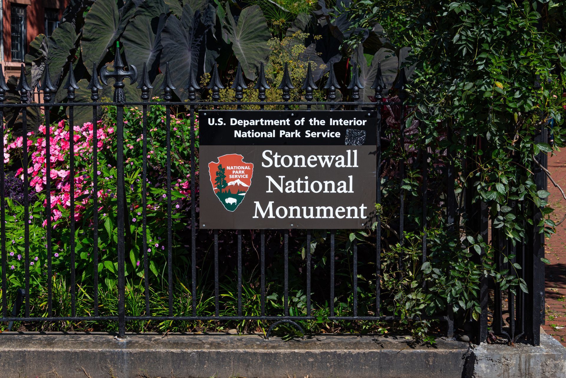 A sign on a fence says stonewall national monument
