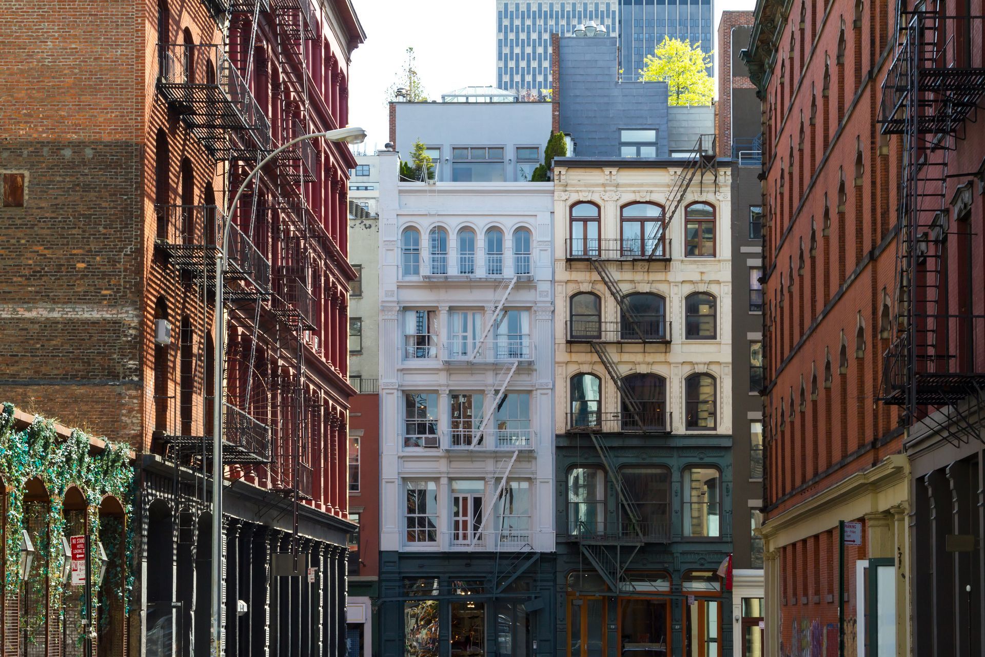 A city street with many buildings and a fire escape