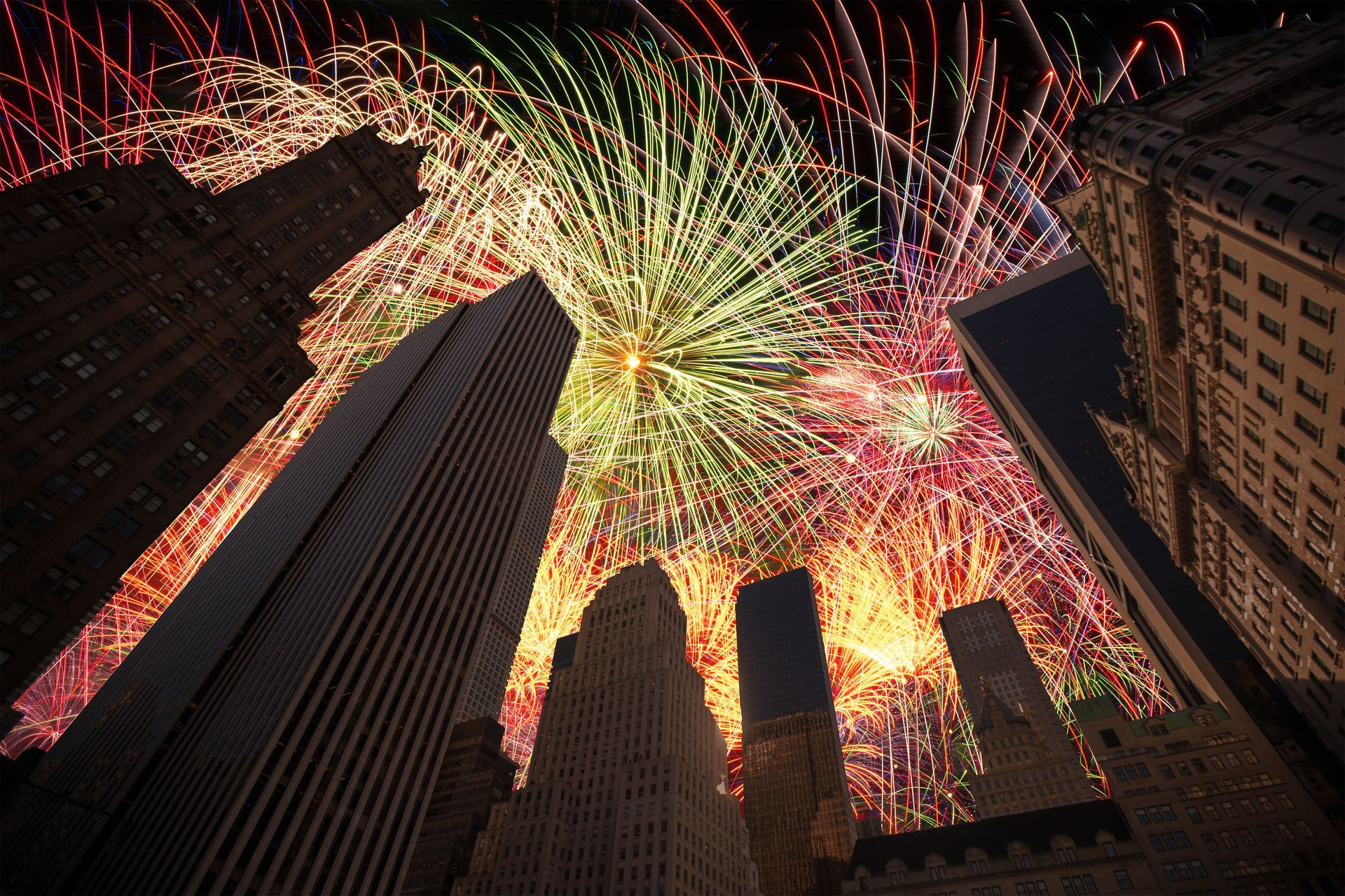 Fireworks are displayed over a city at night