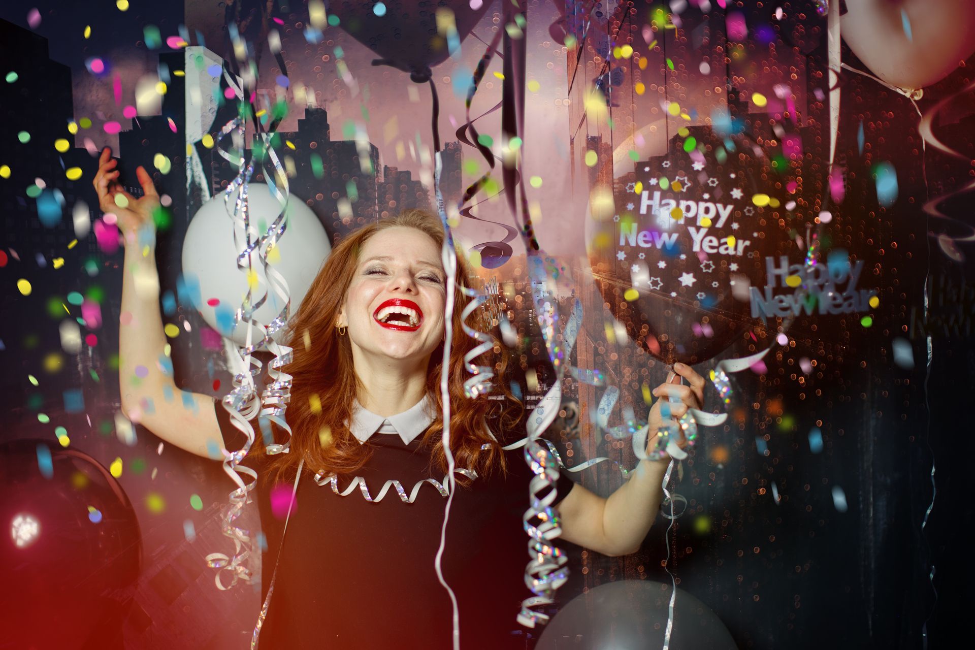 A woman is holding balloons and confetti at a new year 's eve party.