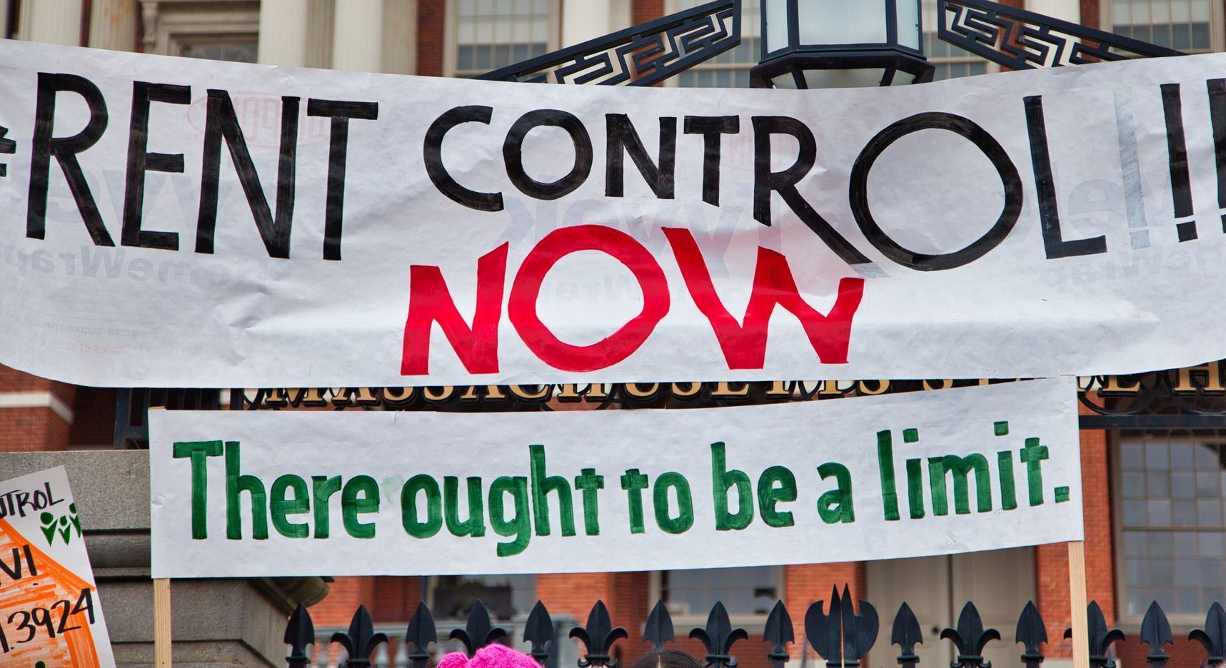 A sign that says rent control now on it