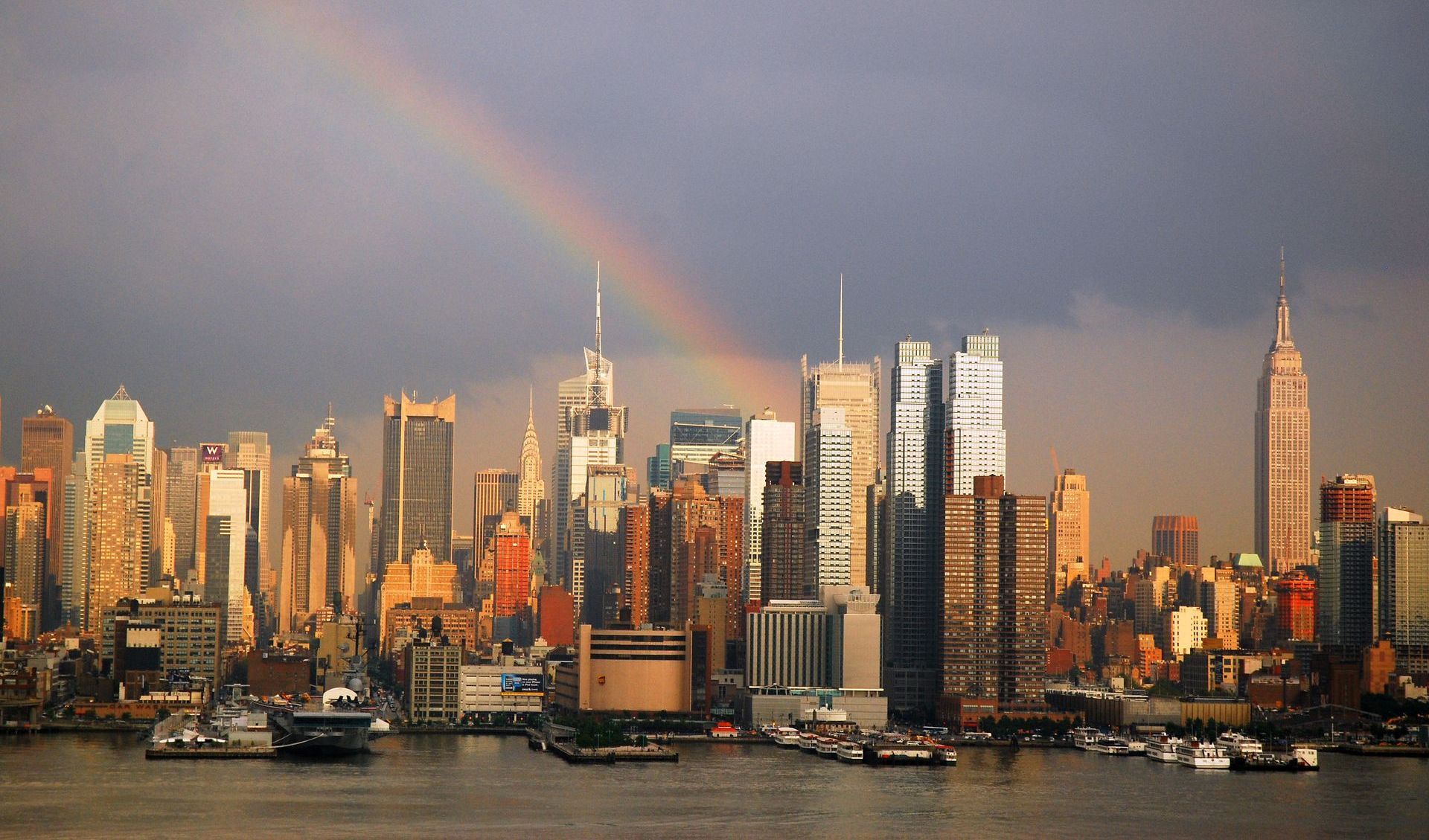 A city skyline with a rainbow in the sky