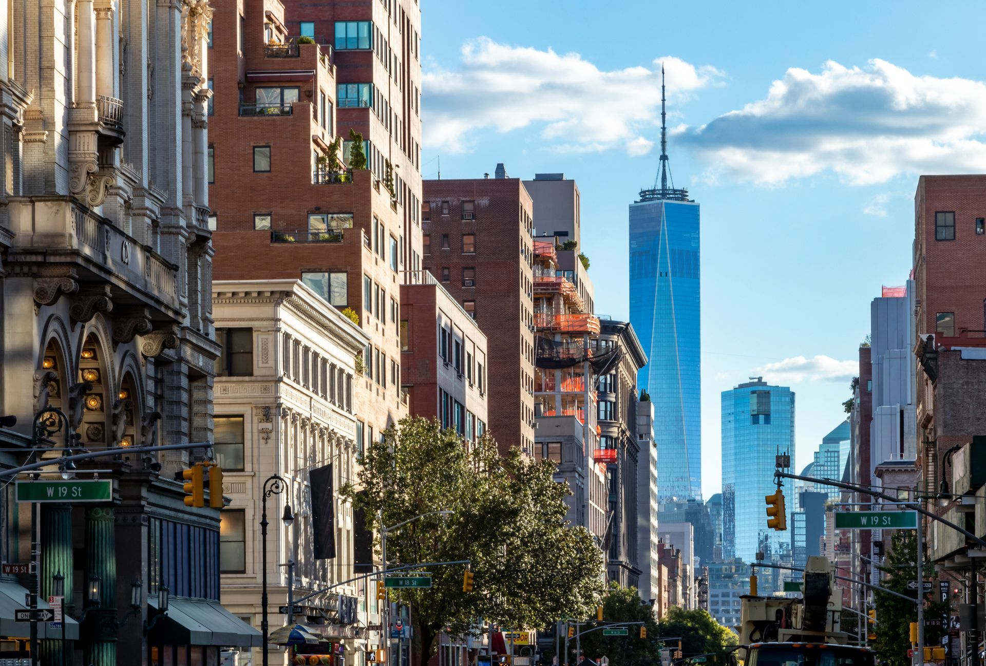 A city street with a skyscraper in the background.