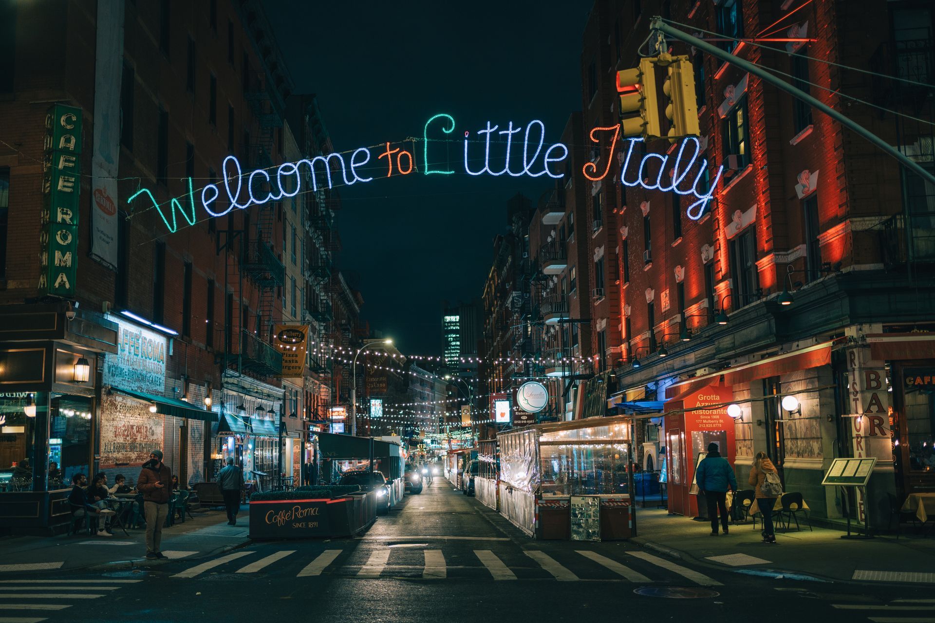 Nighttime street scene in Little Italy, New York City, with neon