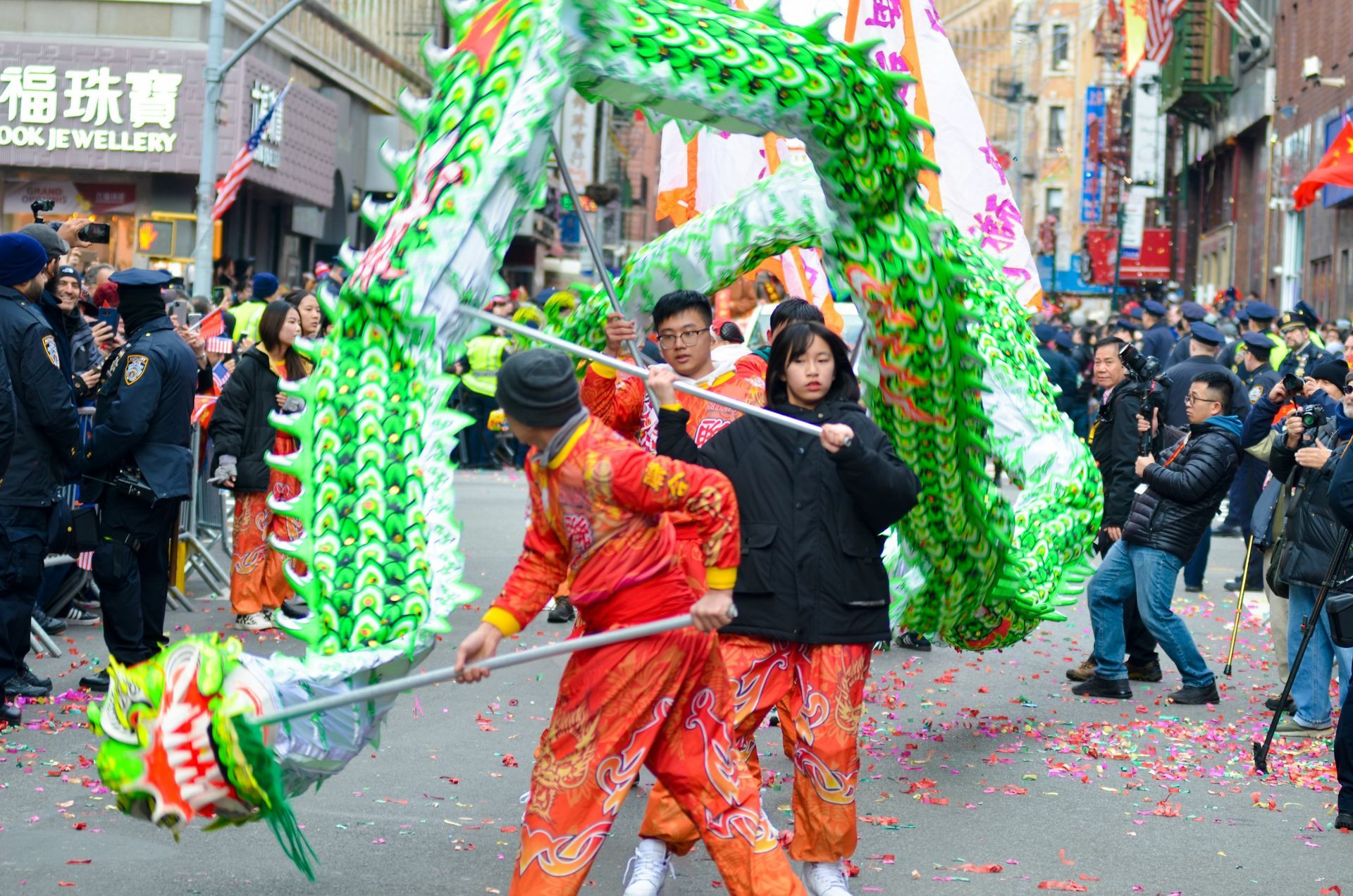 A group of people are holding a dragon in a parade.