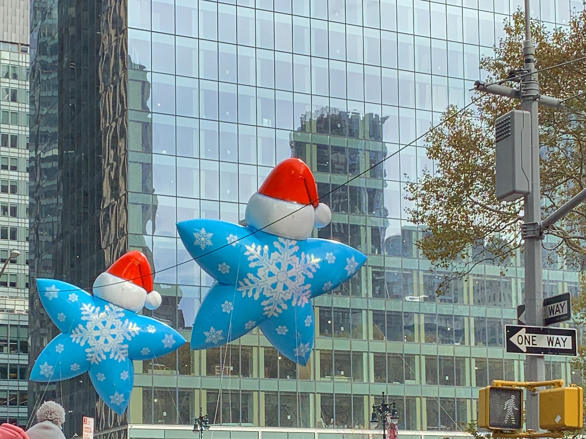 Parade balloons in front of a city building.