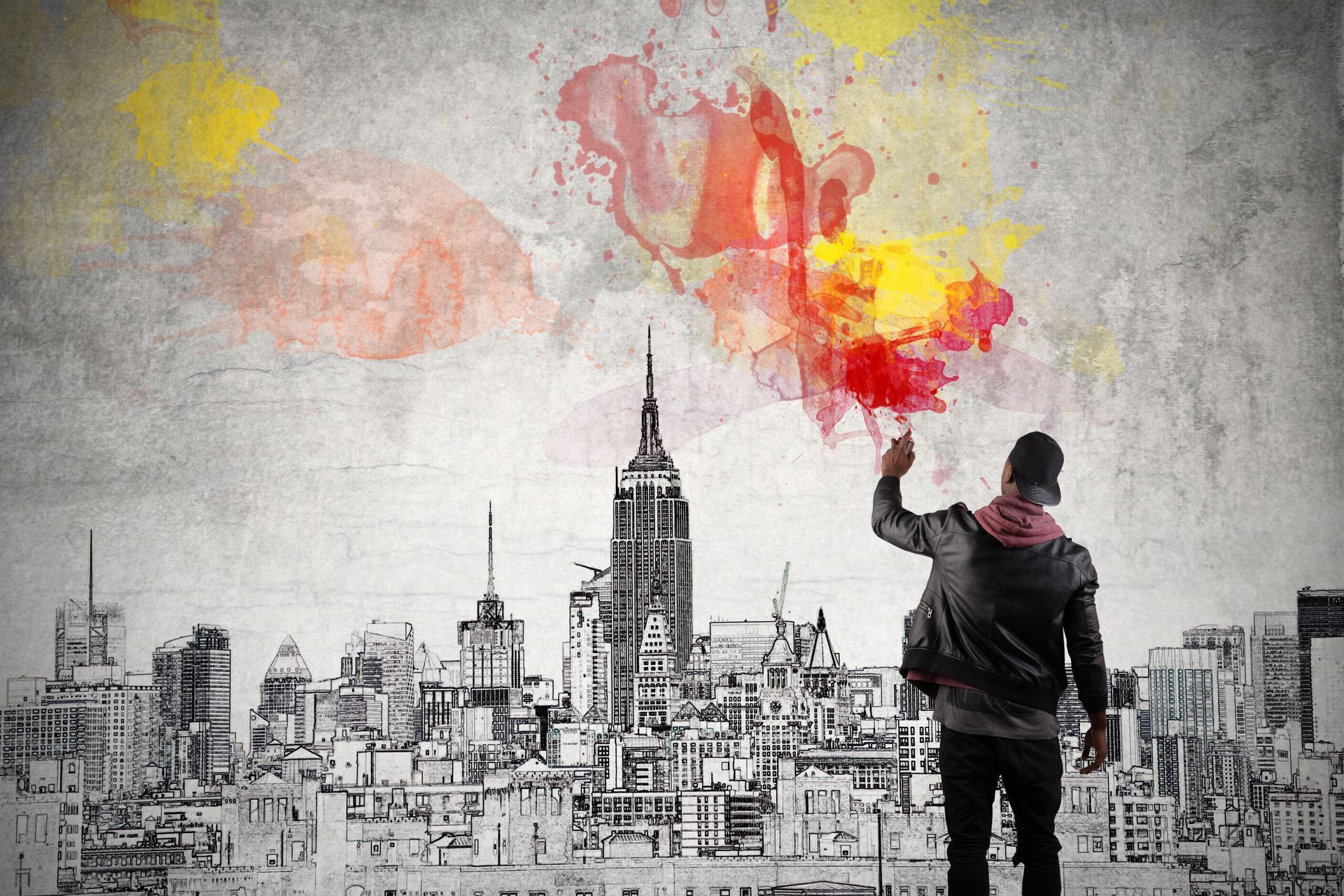 A man is holding a balloon in front of a city skyline.
