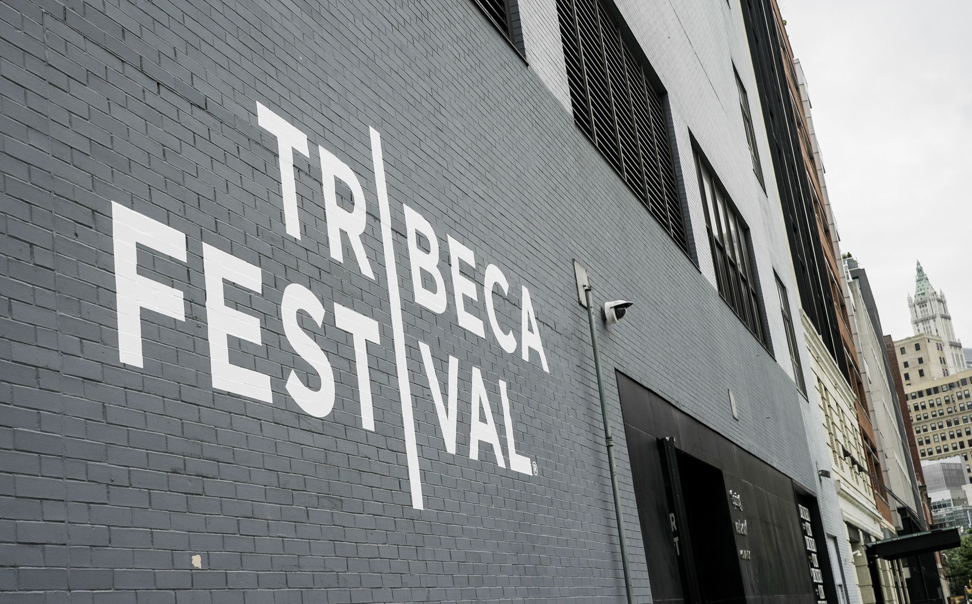 A brick wall with the words tribeca festival painted on it