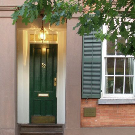 a green door with the number 32 on it