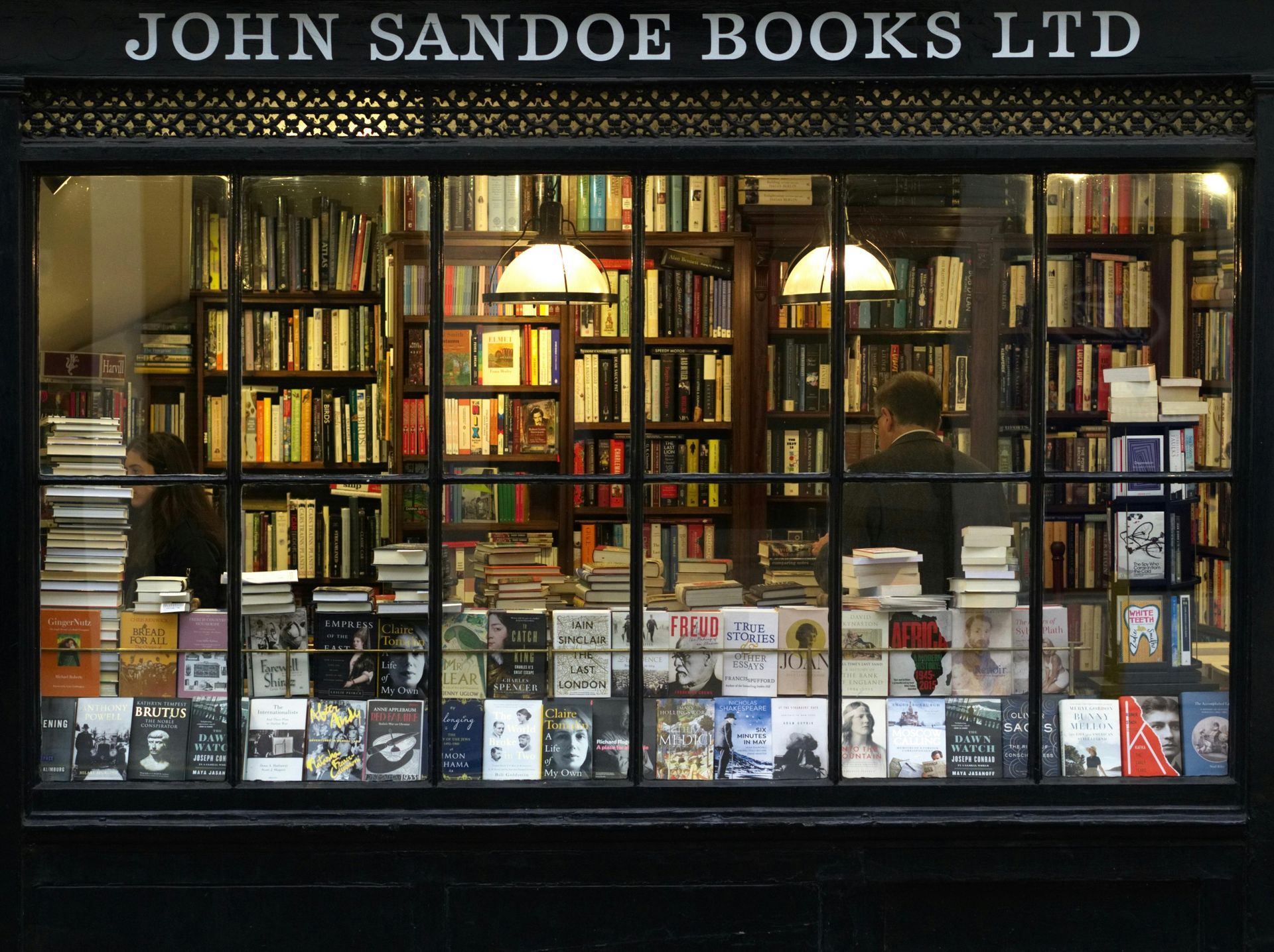 A man and a woman are looking at books in a bookstore.