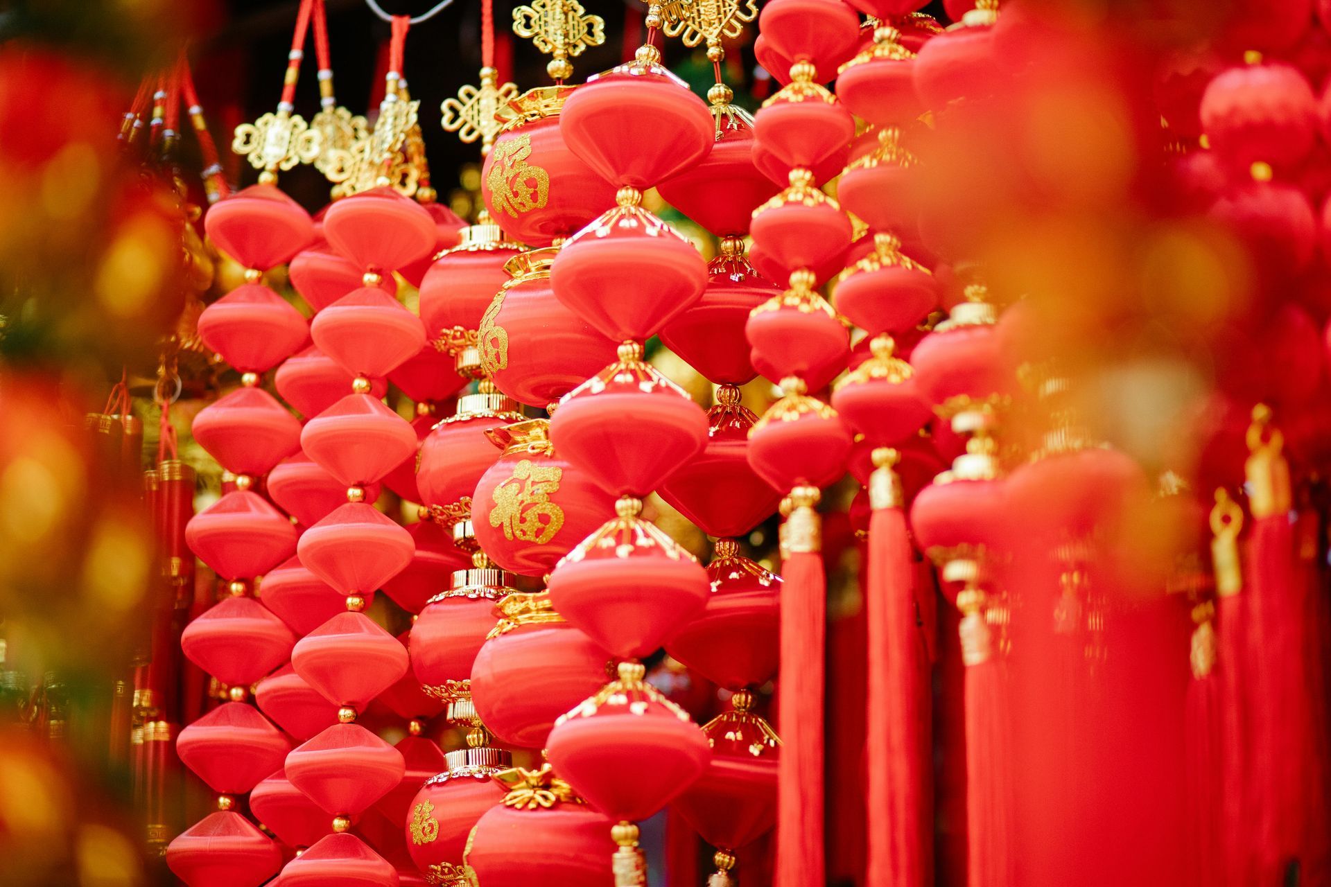 A bunch of red lanterns hanging from a string.