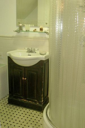 a bathroom with a sink , shower and mirror .
