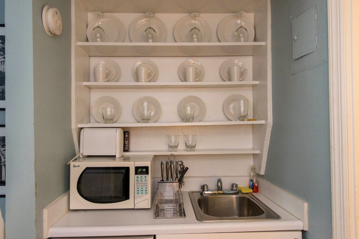 a small kitchen with a microwave and sink