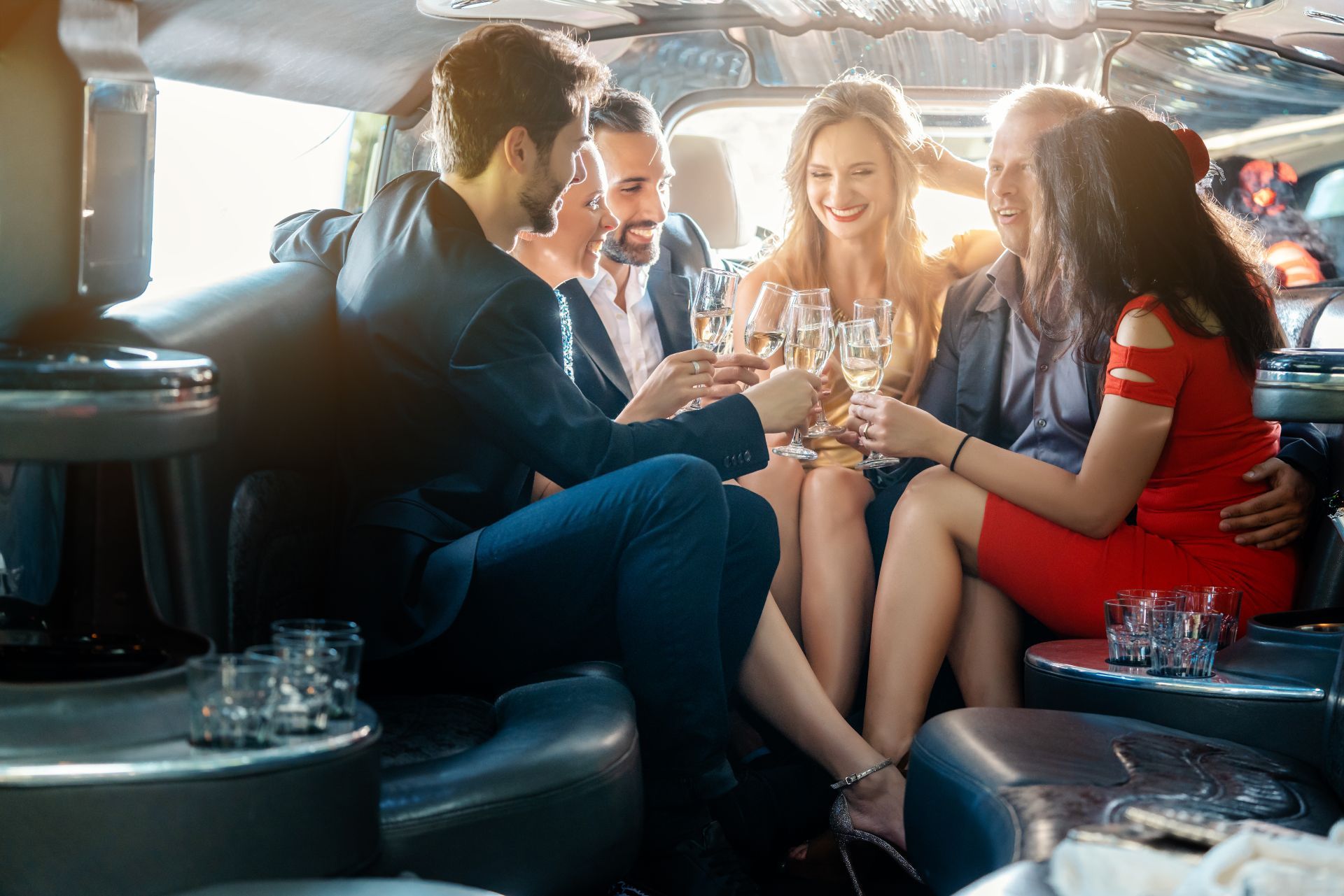 People toasting champagne in a limousine.
