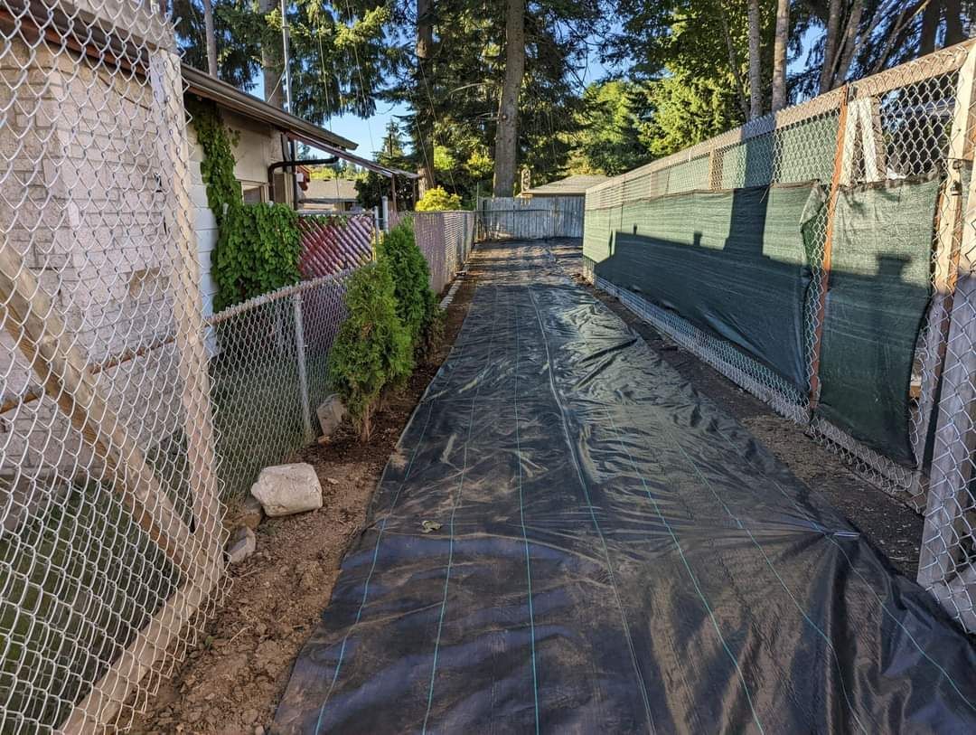 A Black Tarp Is Covering A Dirt Path Next To A Chain Link Fence -  Shelton, WA - D&T Excavating LLP