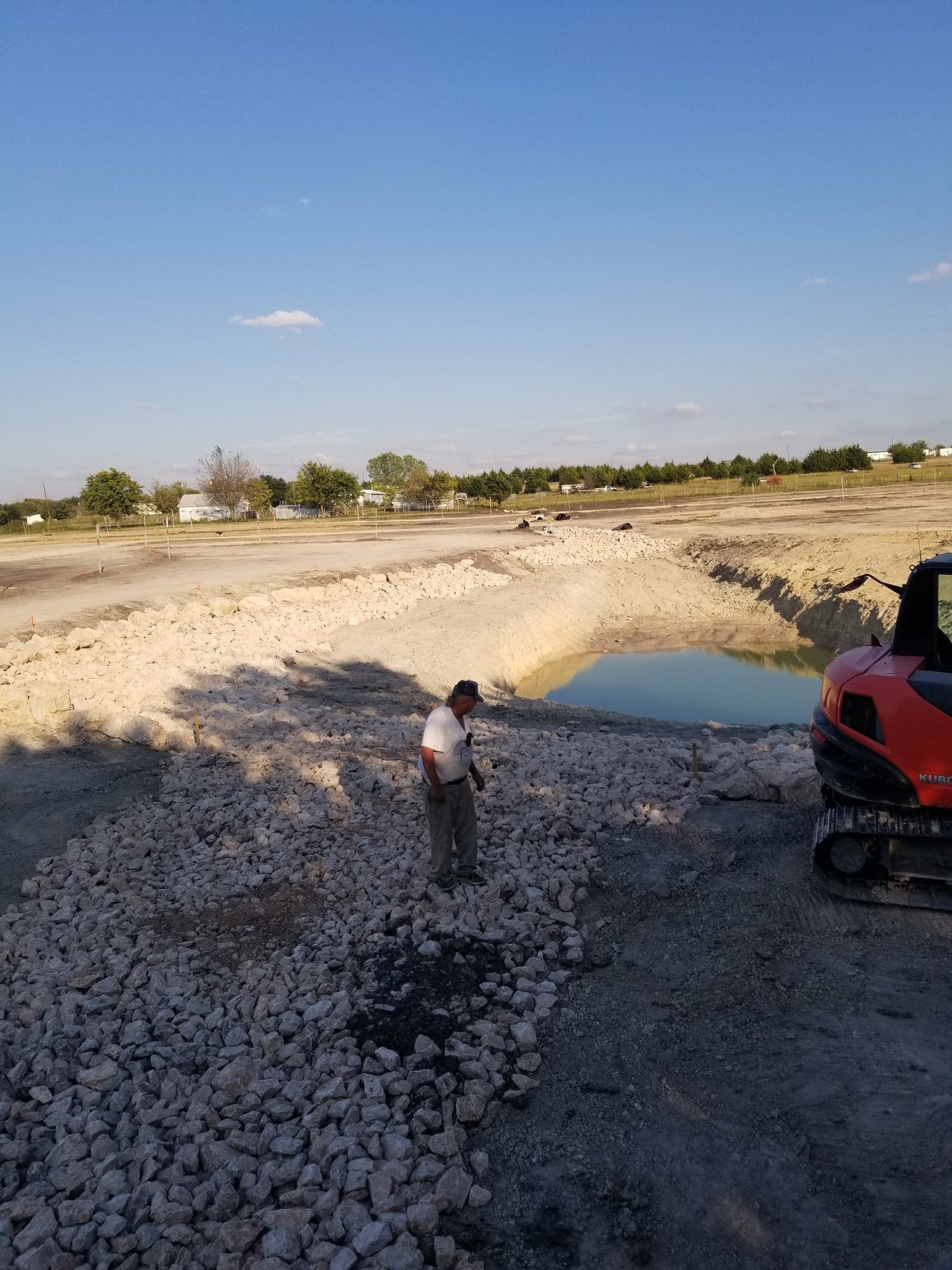 The Man Standing on the Pieces of Rocks - Dallas, TX - All Around Septic Service Co