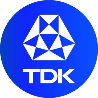 TDK logo in white on a blue circle with a geometric emblem above the letters.