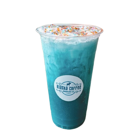 A clear plastic cup of bright blue iced coffee topped with sprinkles and whipped cream, branded with an Alaska Coffee logo.