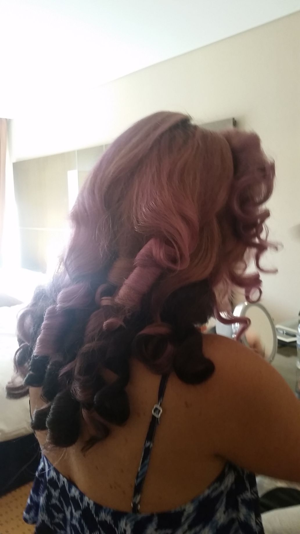 A Woman With A Curly Hairstyle Wearing A Blue Dress — Spiroll Heated Rollers in Redlynch, QLD