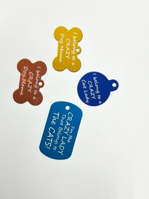 A dog tag that says i belong to a crazy dog mama