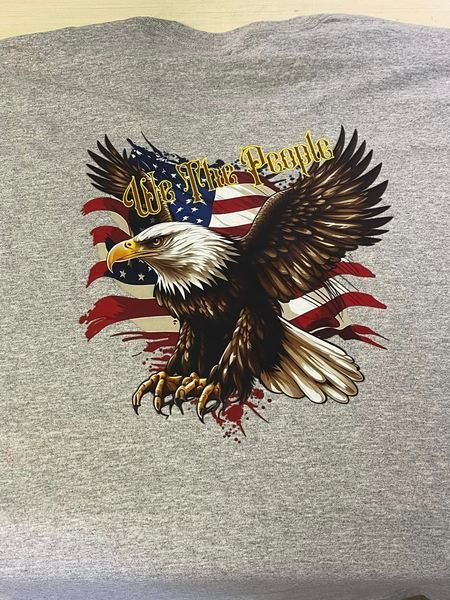A bald eagle is flying in front of an american flag