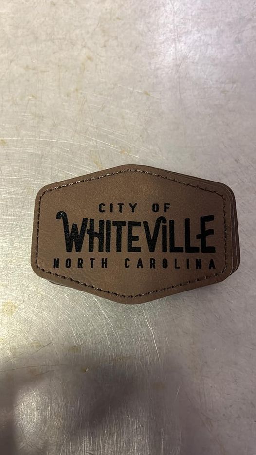 A brown leather patch laser engraved and custom patches made on site, and quick