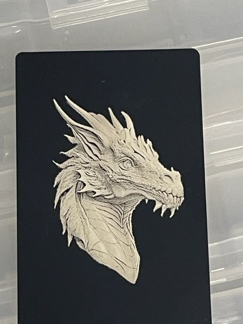 A drawing of a dragon 's head on a black background