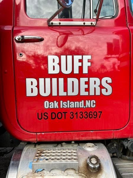 A red truck that says buff builders on it