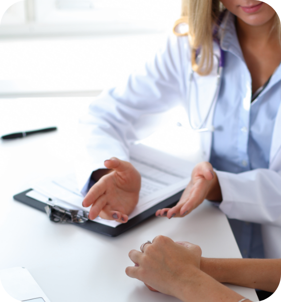 A doctor is talking to a patient while holding a clipboard