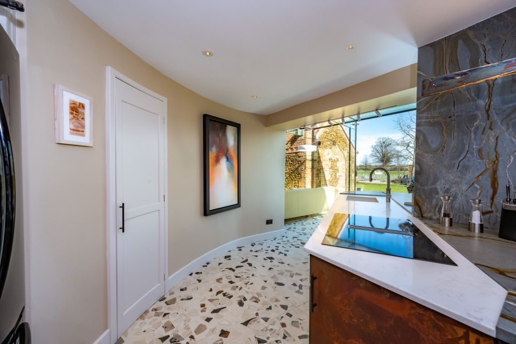A kitchen with a large window and a stove top oven.