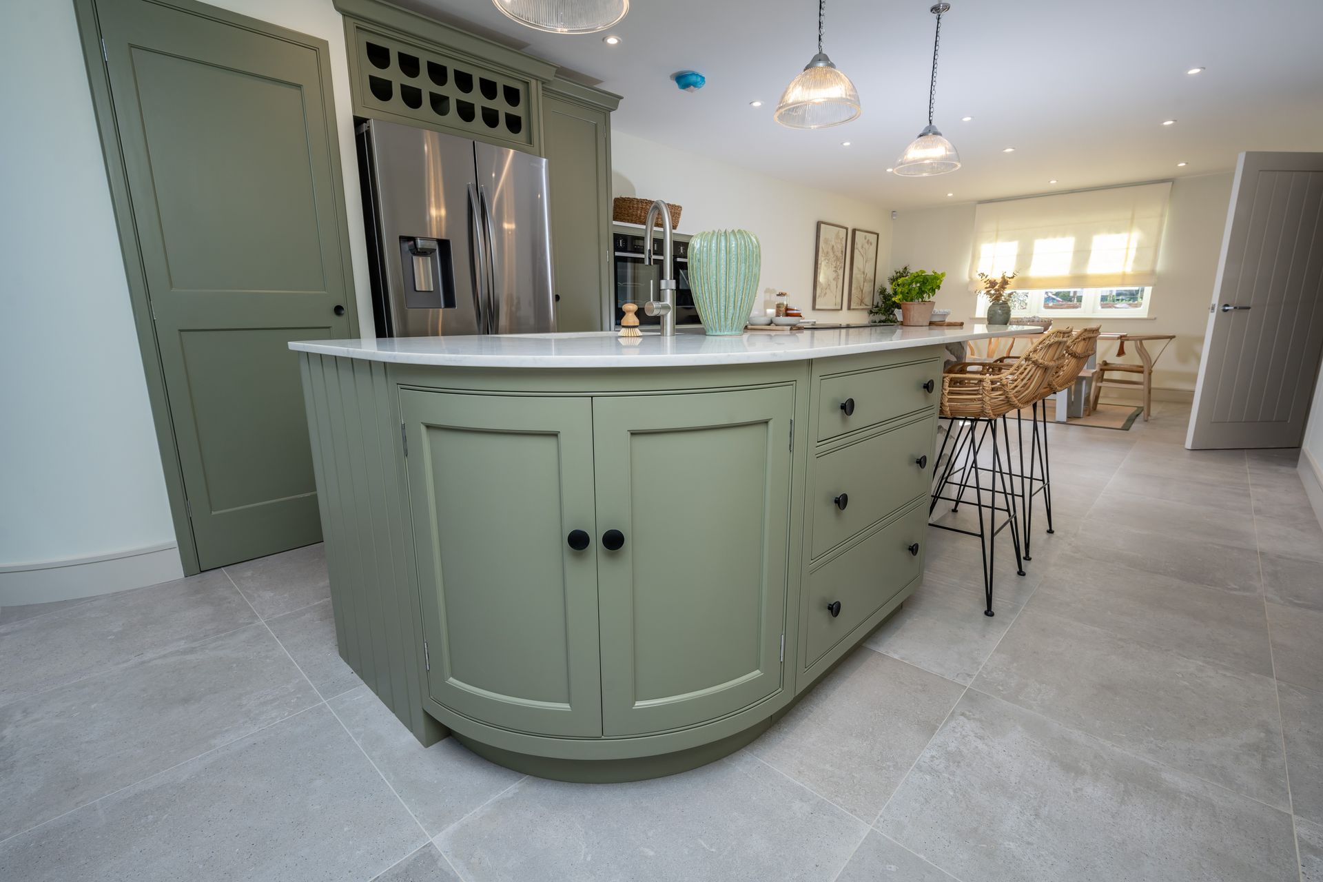 A living room with a couch , chairs , tables and a skylight.