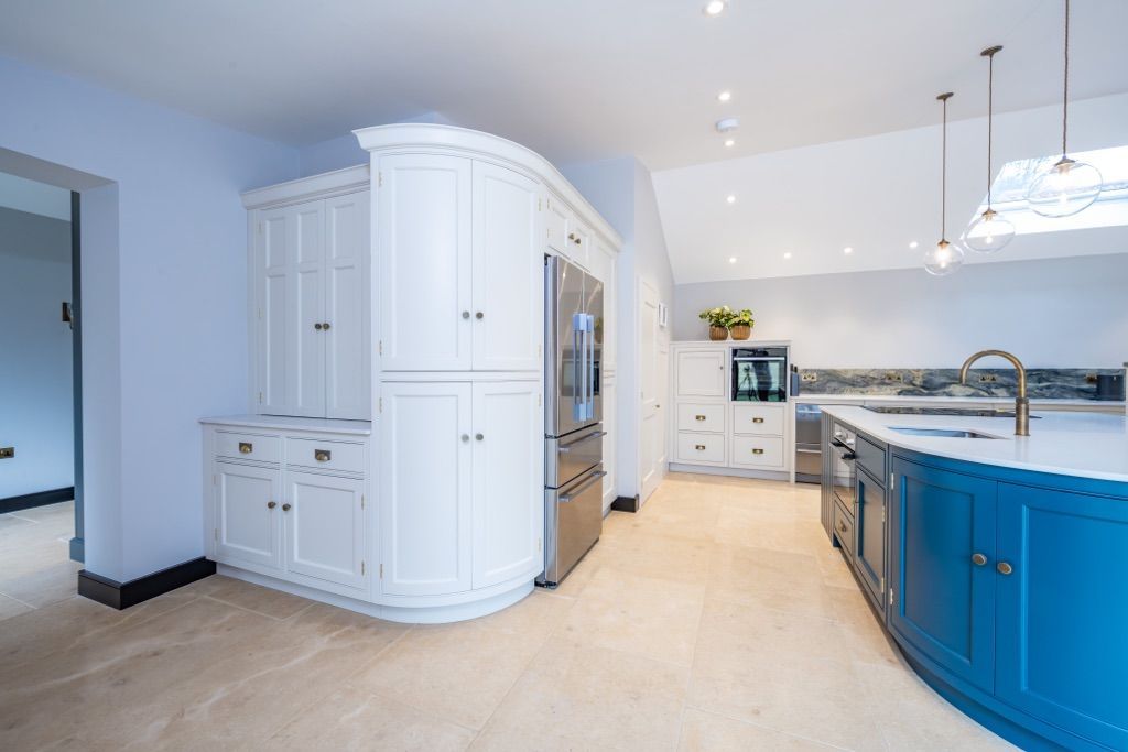 A large kitchen with blue cabinets and white cabinets