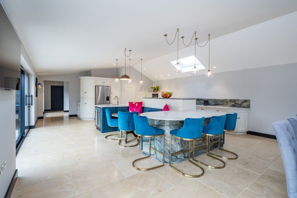 A large kitchen with a table and chairs in it