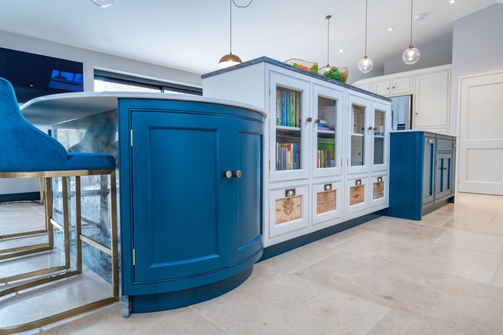 A kitchen with blue cabinets and a white counter top.