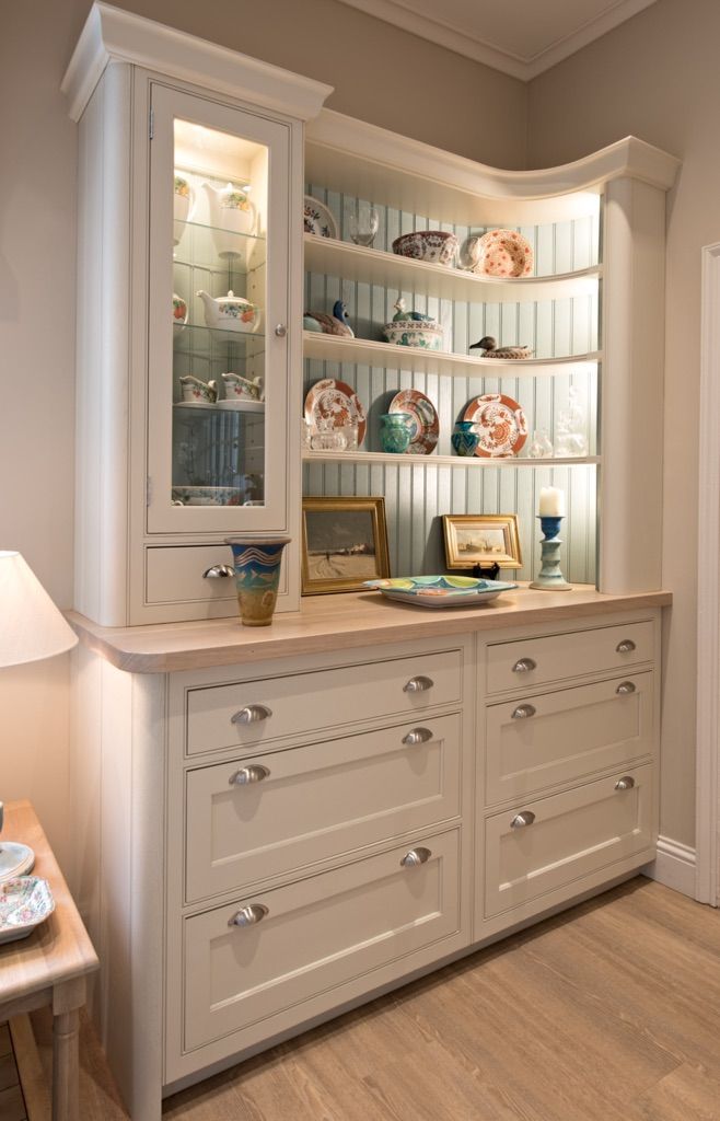 A white cabinet with drawers and shelves in a room.