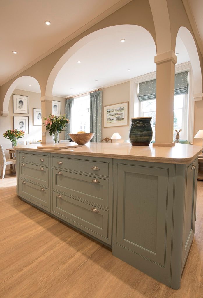 A kitchen with a large island in the middle of the room.
