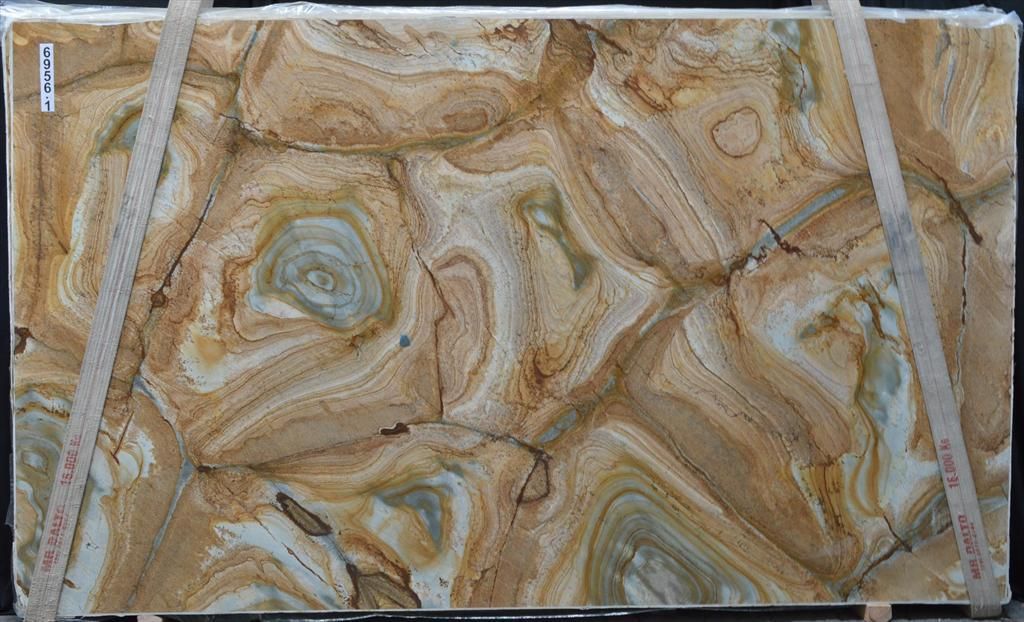 A large piece of marble with a swirl pattern is sitting on a table.