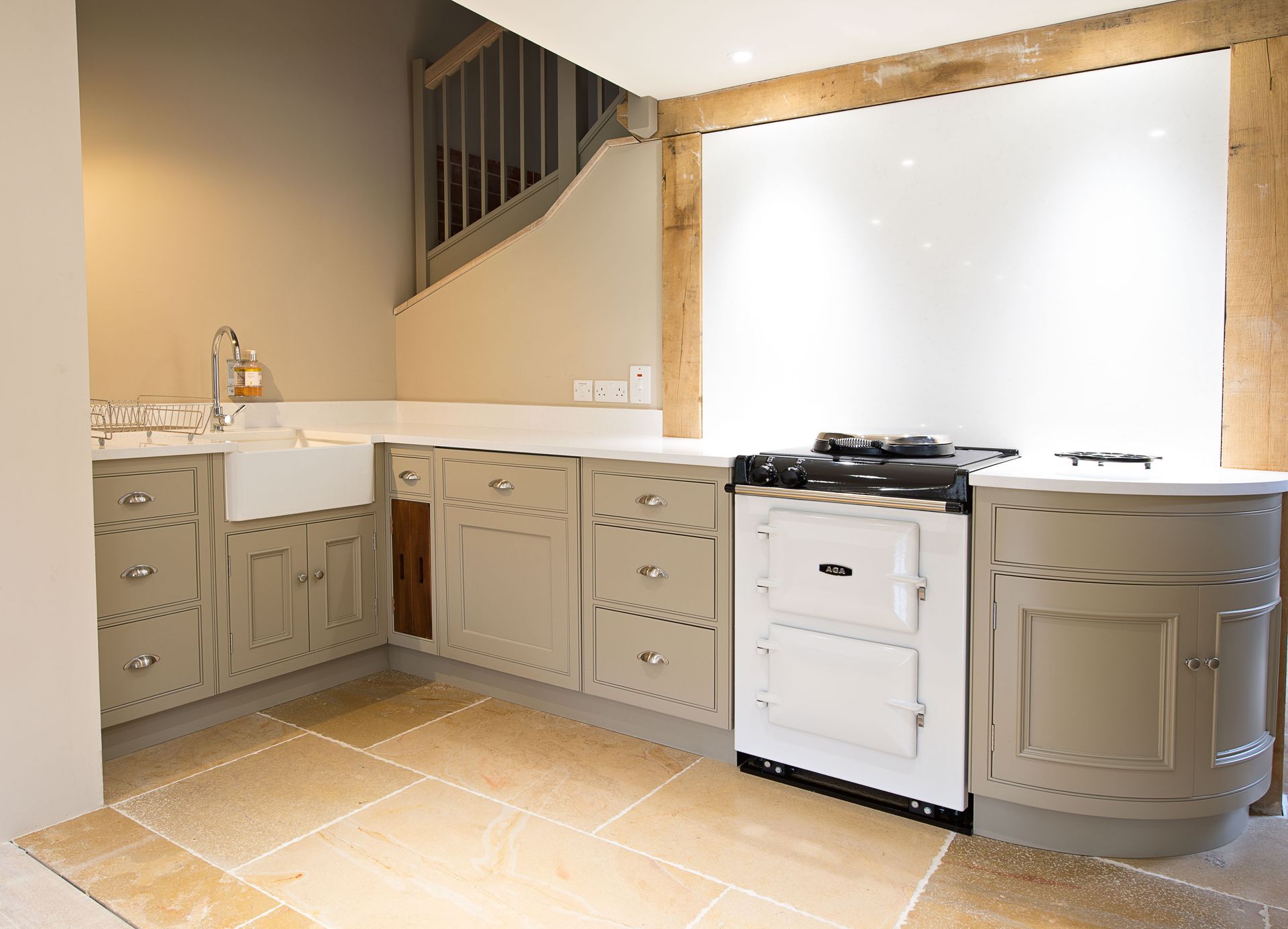 A kitchen with white cabinets and a white stove top oven