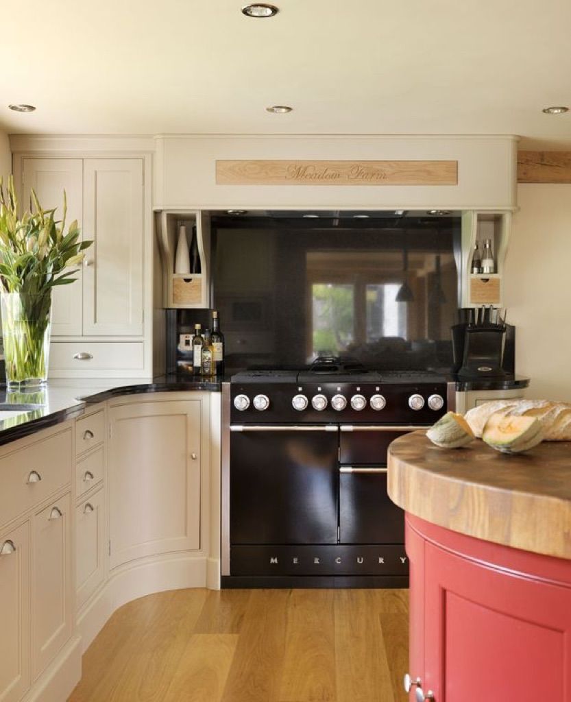 A kitchen with a black stove and a flat screen tv