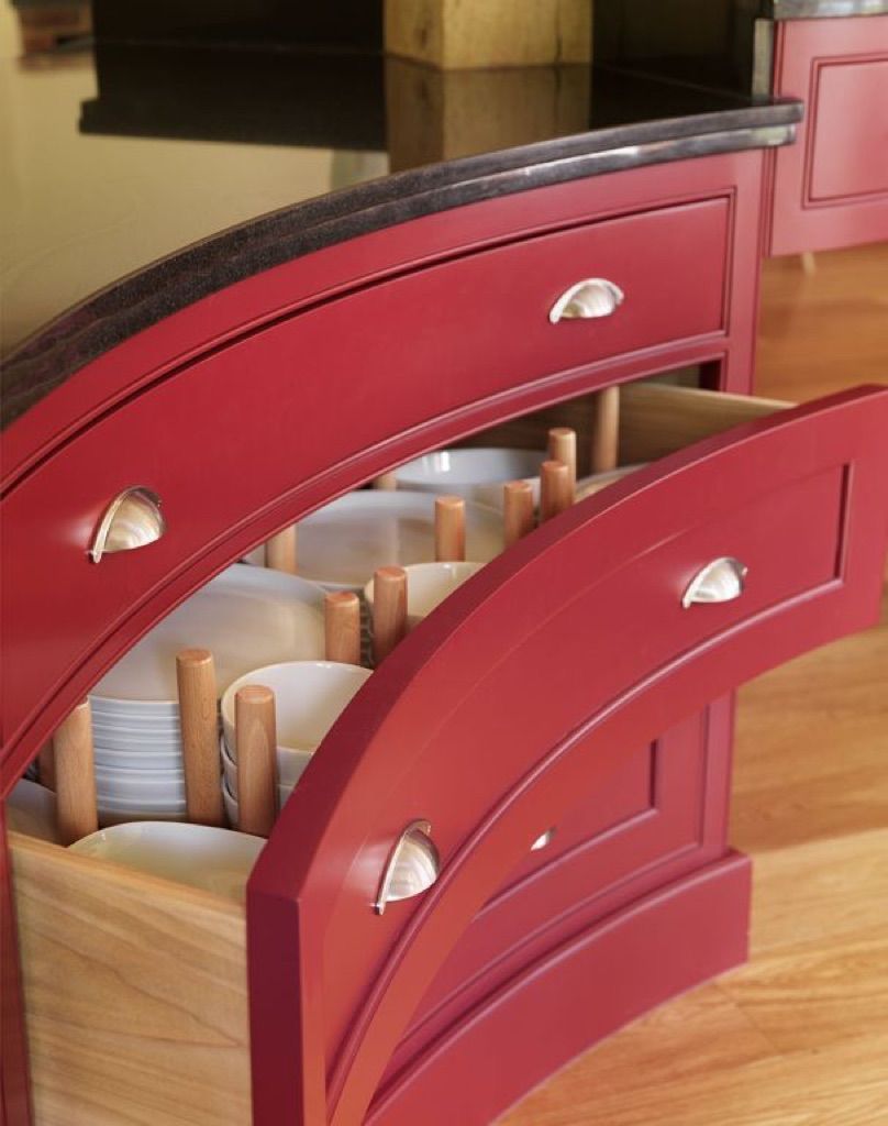 A red drawer with plates and utensils in it