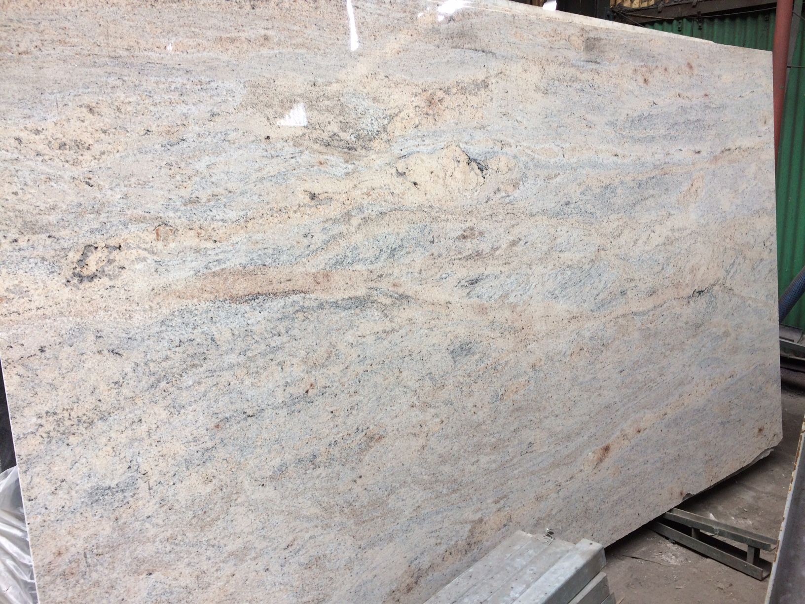 A large white granite slab is sitting on top of a table.