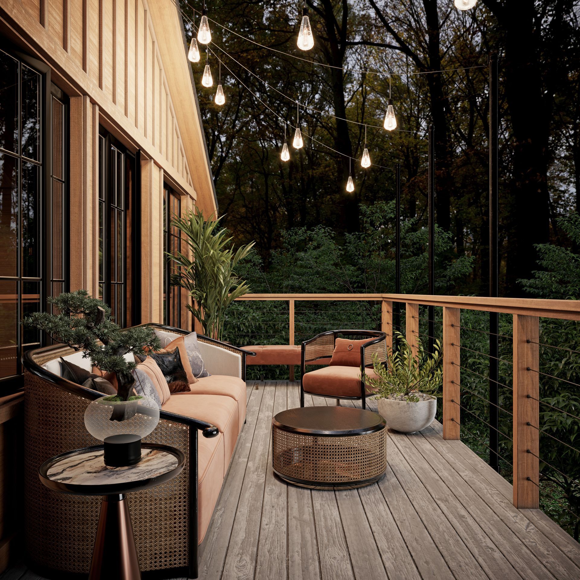 Wooden deck with seating area overlooking a dark forest; string lights overhead.