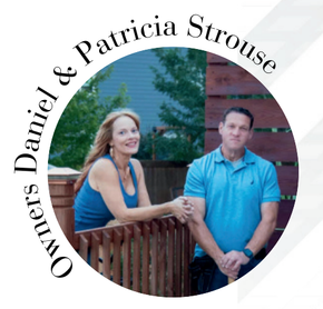 Owners Daniel & Patricia Strouse, smiling couple leaning on a deck railing.